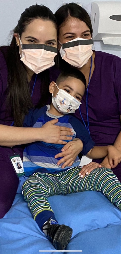 A young patient with his nurses at a hospital
