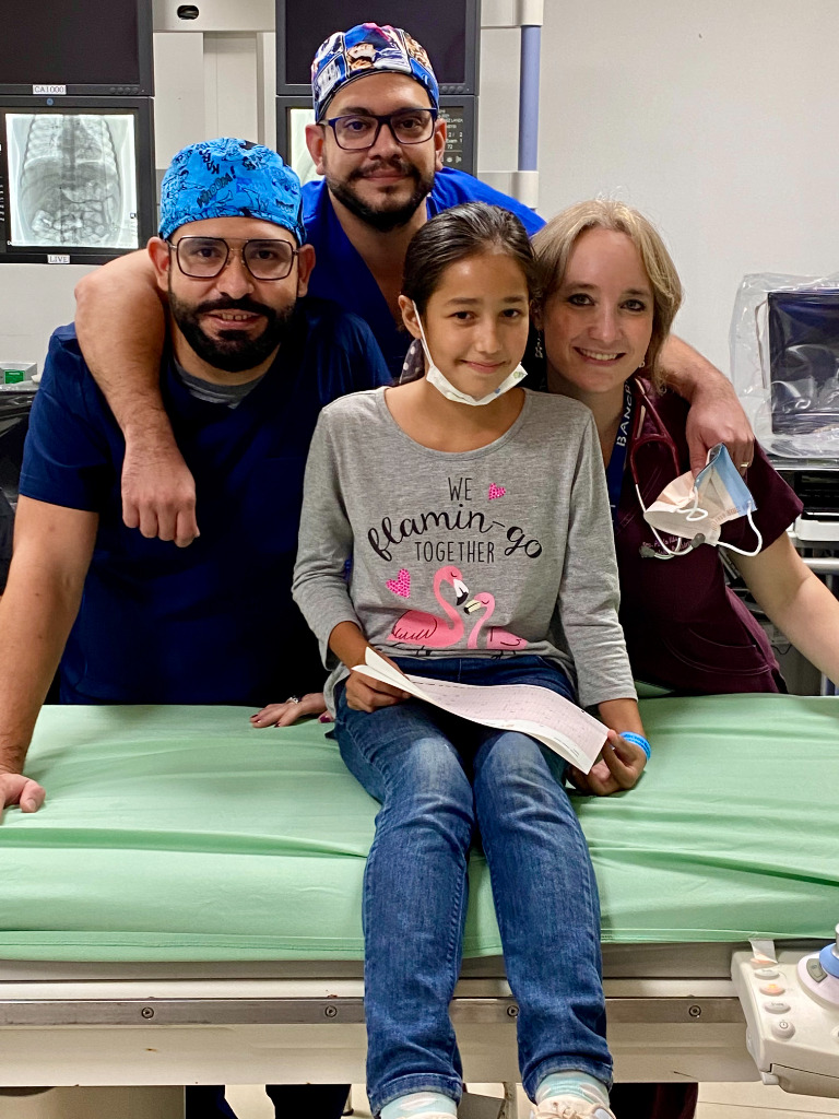 A young patient with her nurses at a hospital